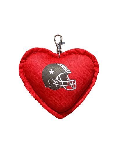 Red heart-shaped keychain with a football helmet design on a white background