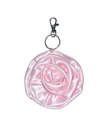 Pink rose-shaped keychain on a white background